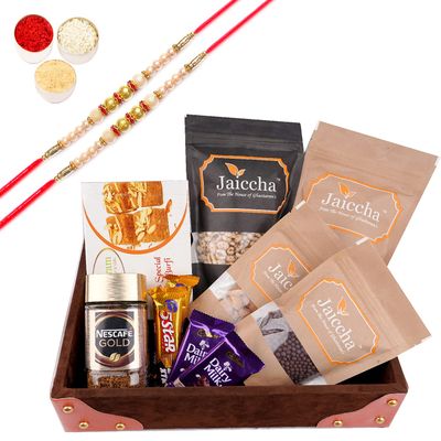 Jaiccha Ghasitaram Rakhi Gifts for Brothers Korno Tray of 10 Goodies with Besan Barfi and with 2 Pearl Rakhis
