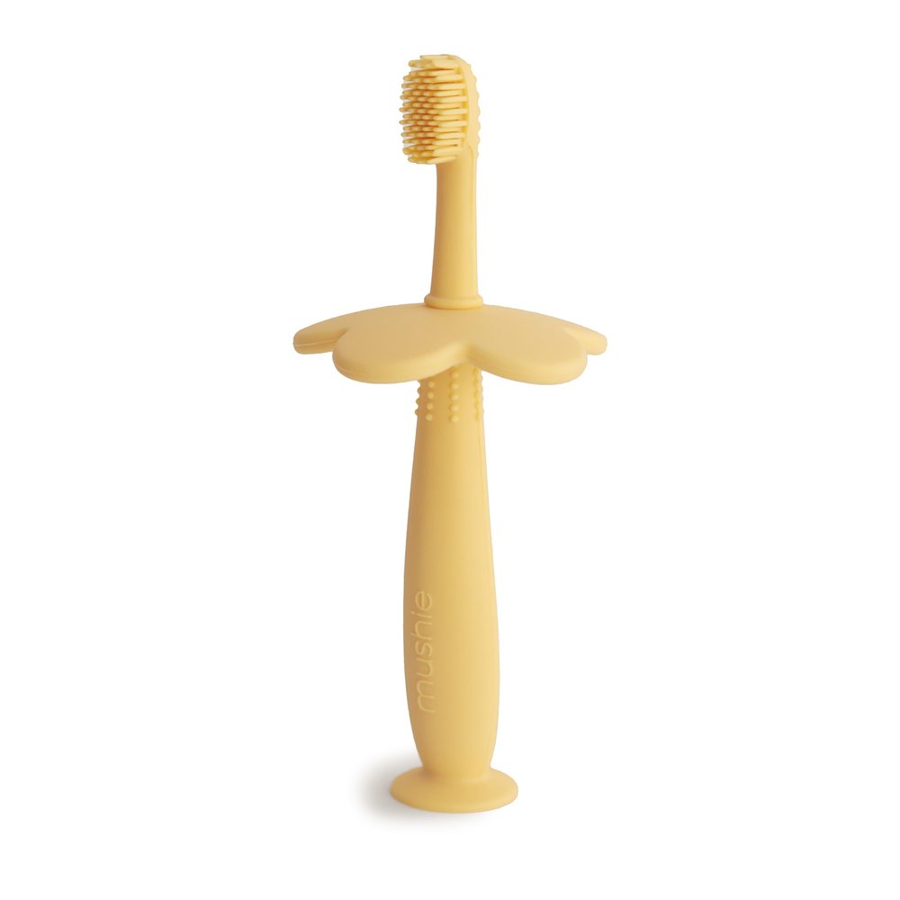 Mushie Silicone Training Toothbrush, for Infants and Toddlers, Suction Base for Easy Storage & Training, Material: Food Grade Silicone, Flower Design (Pale Daffodil)