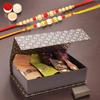 Ghasitaram Gifts Jaiccha Rakhi Gifts for Brothers - Black Gift Box with bites and cookies with 2 Rakhis view 1