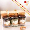 Ghasitaram Gifts Jaiccha Rakhi Gifts for Brothers - 3 jars Orange Box with assorted nuts and crispies with 2 Rakhis view 1