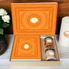 Ghasitaram Gifts Jaiccha Holi- Sweets/Holi Hampers/Thandai Ghasitaram Orange Hamper Box with Assorted Gujiyas, Thandai and Mixed Nuts Jars view 1