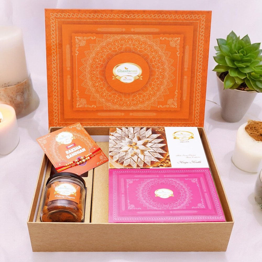 Ghasitaram Gifts Jaiccha Rakhi Gifts for Brothers Orange Hamper Box with Kaju Katli, Milk Cake, 2 Rakhis, Card, and Mixed Dryfruit Jar